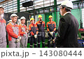 The manager gave a training speech to the workers before they started working in the factory. 143080444