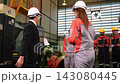 The manager gave a training speech to the workers before they started working in the factory. 143080445
