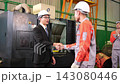 The manager gave a training speech to the workers before they started working in the factory. 143080446