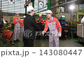 The manager gave a training speech to the workers before they started working in the factory. 143080447