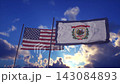 West Virginia State Flag and American Flag Waving Against Dramatic Sky 143084893
