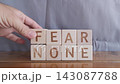 motivational word Fear none, laying out by hand from letters on wooden cubes, slow motion 143087788