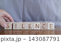 motivational word Silence, laying out by hand from letters on wooden cubes, slow motion 143087791
