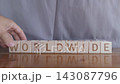 motivational word Worldwide, laying out by hand from letters on wooden cubes, slow motion 143087796