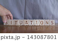 motivational word Situations, laying out by hand from letters on wooden cubes, slow motion 143087801