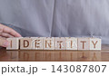 motivational word Identity, laying out by hand from letters on wooden cubes, slow motion 143087807