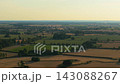 Rural farmland with green crops and harvested fields under warm evening light. Diverse agricultural land for crop farming and seasonal production. Countryside property for agribusiness growth and farm 143088267