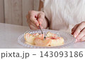 A woman's hands eating a peach 143093186