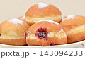 Video of Berliners (German donuts) with raspberry jam and powdered sugar 143094233