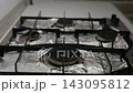 Close-up video of person lighting all four gas burners on stove. Surface protected with aluminum foil. Blue flames appear one by one as knobs turned. Ready for cooking, closeup, slow motion. 143095812