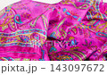 A silk scarf with colorful patterns drops smoothly down in slow motion. The fabric moves gracefully against a clean white backdrop. This elegant motion is perfect for luxury fashion. 143097672