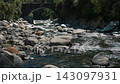 Slow-motion footage of alpine water flowing beneath old bridge on a sunny summer afternoon 143097931