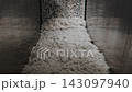 Processed white textile raw material blended in large industrial chamber. Wool processing and recycling stage in Italian factory. 143097940