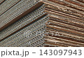 Diagonal layers of stacked corrugated cardboard in industrial plant 143097943