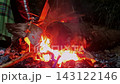 Vibrant bonfire with burning logs and glowing embers, providing warmth and .. 143122146