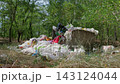 Piles of Plastic Waste Polluting Green Forest Ecosystem in Summer 143124044