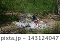 Plastic Garbage Overflowing Concrete Bin in Summer Green Forest 143124047