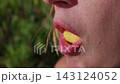 Woman Chewing Food Outdoors in Slow Motion with Close Up on Lips 143124052