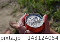 Open Can of Fizzy Soda Bubbling in Hands Outdoors in Slow Motion 143124054