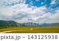 static timelapse of white clouds flowing above mountain valley in Kyrgyzstan 143125938
