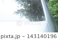 rain falling and water splashing on back windshield car in parking 143140196