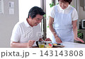 A senior man being served meals at a nursing home and a senior female staff member. 143143808