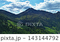 Aerial Hyperlapse Flying Forward Towards Majestic Mountain Peak Under Blue Sky 143144792