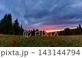 Time Lapse Of Sunset Sky Over Mountain Meadow And Forest Silhouette 143144794