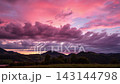 Sunset Timelapse Of Vibrant Pink And Purple Clouds Over Mountain Landscape 143144798