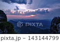 Timelapse Of Sunset Rays And Clouds Over Mountain Range From Rocky Peak 143144799