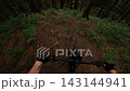 POV Video Of Mountain Biker Riding Fast On Dark Enduro Forest Trail 143144941