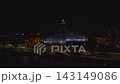 Aerial night view of Latvian National Library in Riga during Staro 2025. Dynamic blue, white and red lights, roofline ribbon, Ferris wheel, river reflections 143149086