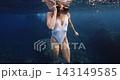 Freediver swimming underwater in clear tropical sea wearing a diving mask. High quality 4k footage 143149585