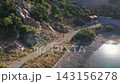 Woman running on coastal trail beside the sea 143156278