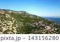 Winding mountain road through rocky landscape with sea view 143156280