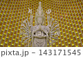 A Majestic MultiArmed Statue in a Radiant Golden Sanctuary Surrounded by Natural Beauty 143171545
