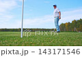 A Golfer Concentrating While Putting on the Green Under a Beautiful Clear Blue Sky and misses the hole in a game of golf 143171546