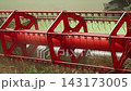 Combine harvester reel spinning and cutting wheat during harvest in a rural farm field in slow motion 143173005