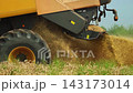 Combine harvester straw chopper spreading shredded wheat residue after harvesting a grain field in slow motion 143173014