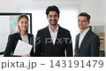 Portrait of multiracial coworkers stand together and smile in corporate workspace. Professional business team ready to work on project in organization office 143191479