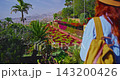 A young female traveler in a hat explores the planet's incredibly beautiful locations solo with a backpack, admiring the scenery. A concept of freedom and solo travel 143200426