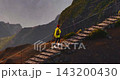 Aerial view of young woman in a yellow jacket and a backpack is hiking up a mountain, surrounded by incredibly beautiful scenery high up in the mountains. A concept of travel and an active lifestyle 143200430