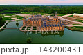 Aerial view of the magnificent French Castle de Chantilly and its picturesque park at sunset near Paris, France 143200431