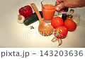 Hand Taking Glass Mug of Fresh Spanish Gazpacho Soup 143203636