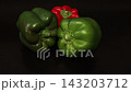 Chef Hands Picking Fresh Green Bell Pepper on Black Background 143203712