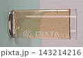 Cold drink in clear glass with bubbles on a table in a bright room 143214216