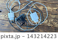 Smartphone chargers and cables displayed on a wooden table 143214223