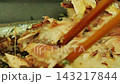Carefully flake the meat off the grilled saury with chopsticks. 143217844
