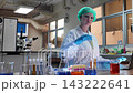 Laboratory room. Female scientists conducting laboratory research with colorful chemical samples. Using test tubes flasks and microscopes for scientific analysis and experimentation. Bio or chemical. 143222641