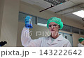 Laboratory room. Female scientists conducting laboratory research with colorful chemical samples. Using test tubes flasks and microscopes for scientific analysis and experimentation. Bio or chemical. 143222642